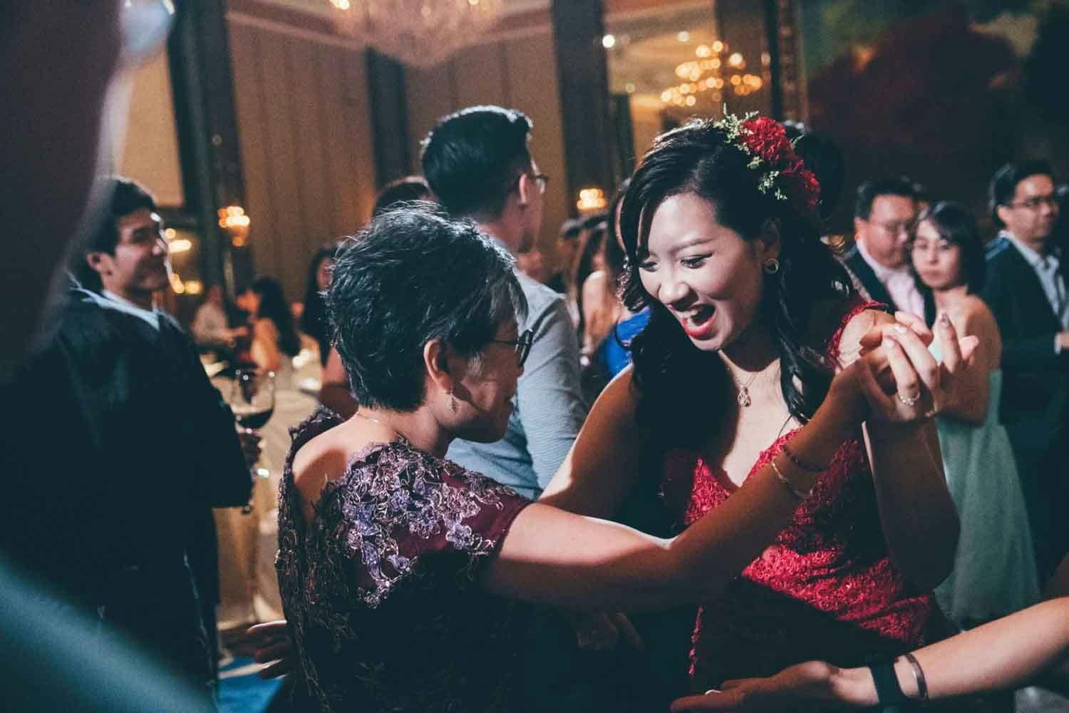 bride and mother dancing in the ballroom hotel best wedding photographer in singapore actual day