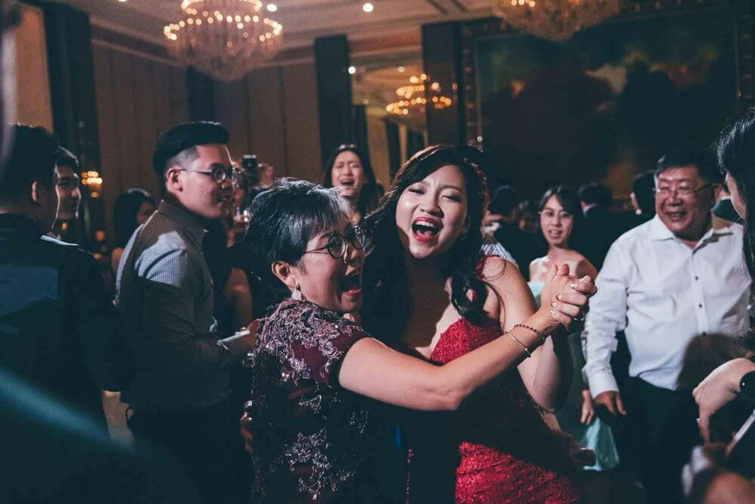 bride and mother dancing in the ballroom hotel best wedding photographer in singapore actual day