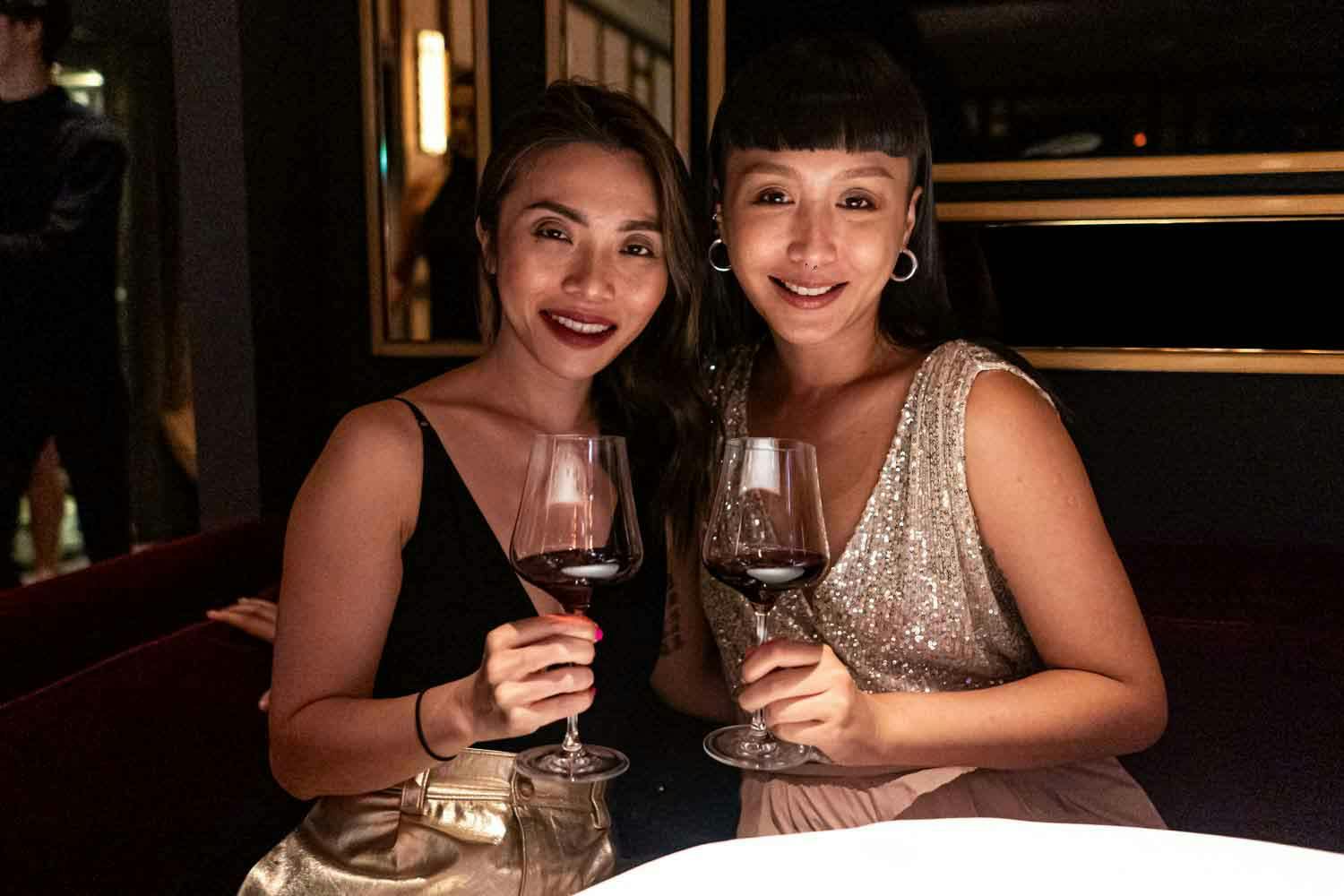 two ladies enjoying red wine at madame fan chinese restaurant