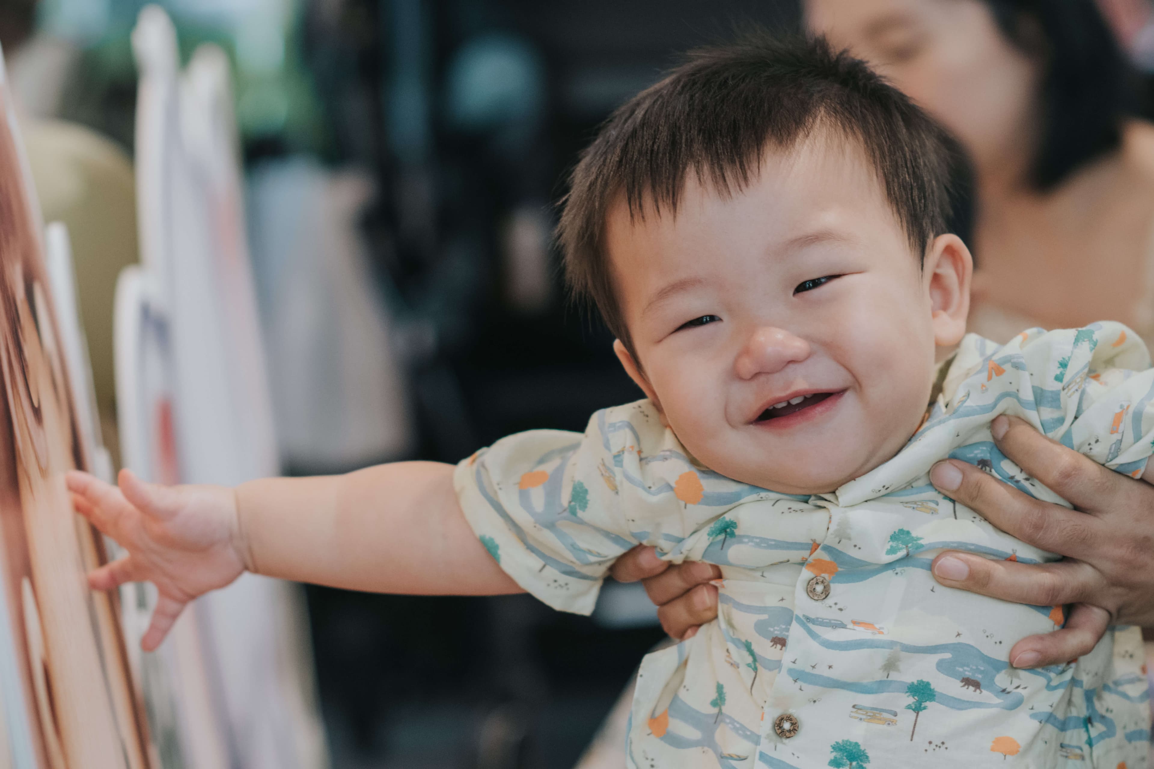 singaporean mother hugging son for 1st baby birthday party celebration