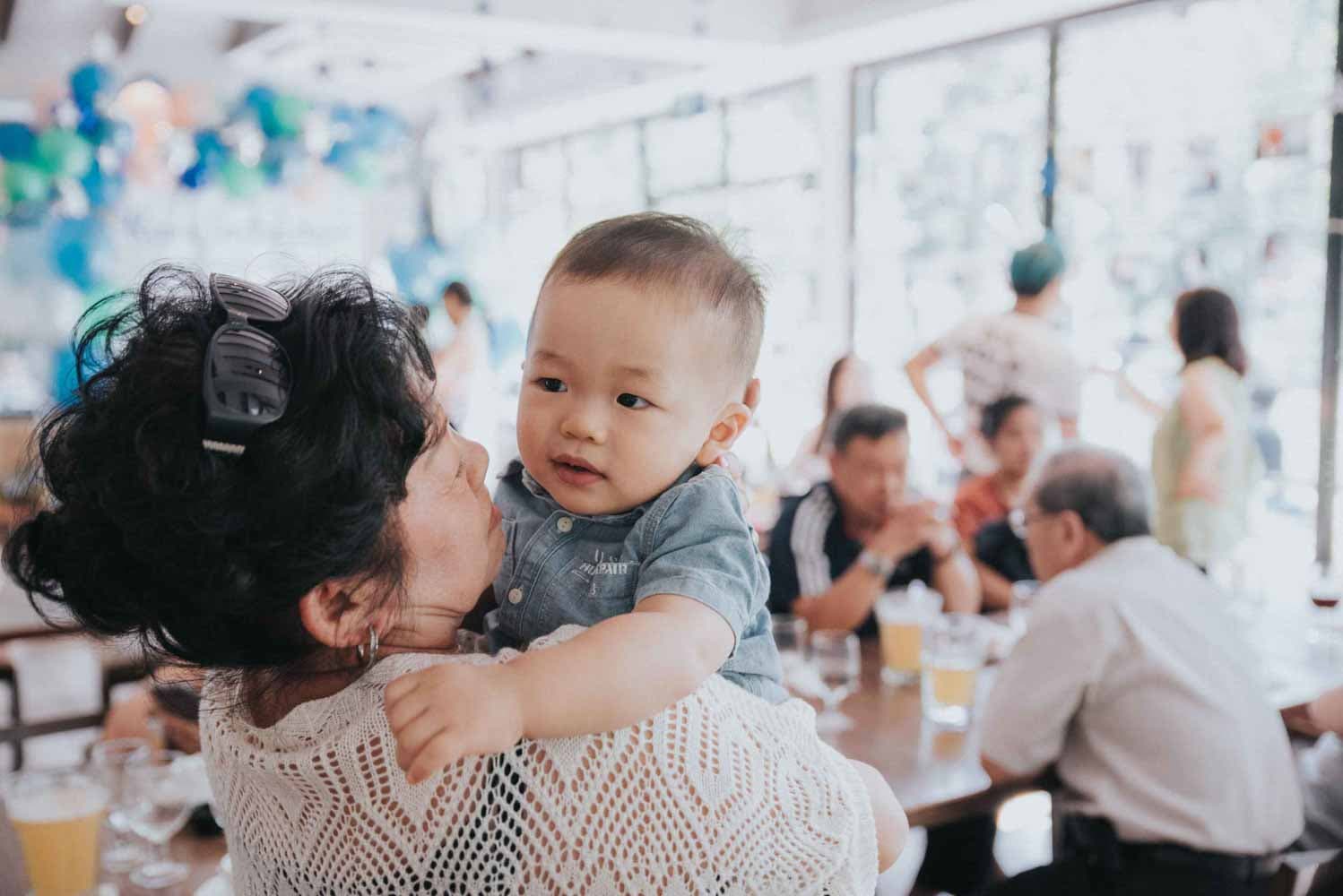lady hugging a baby boy on her shoulder