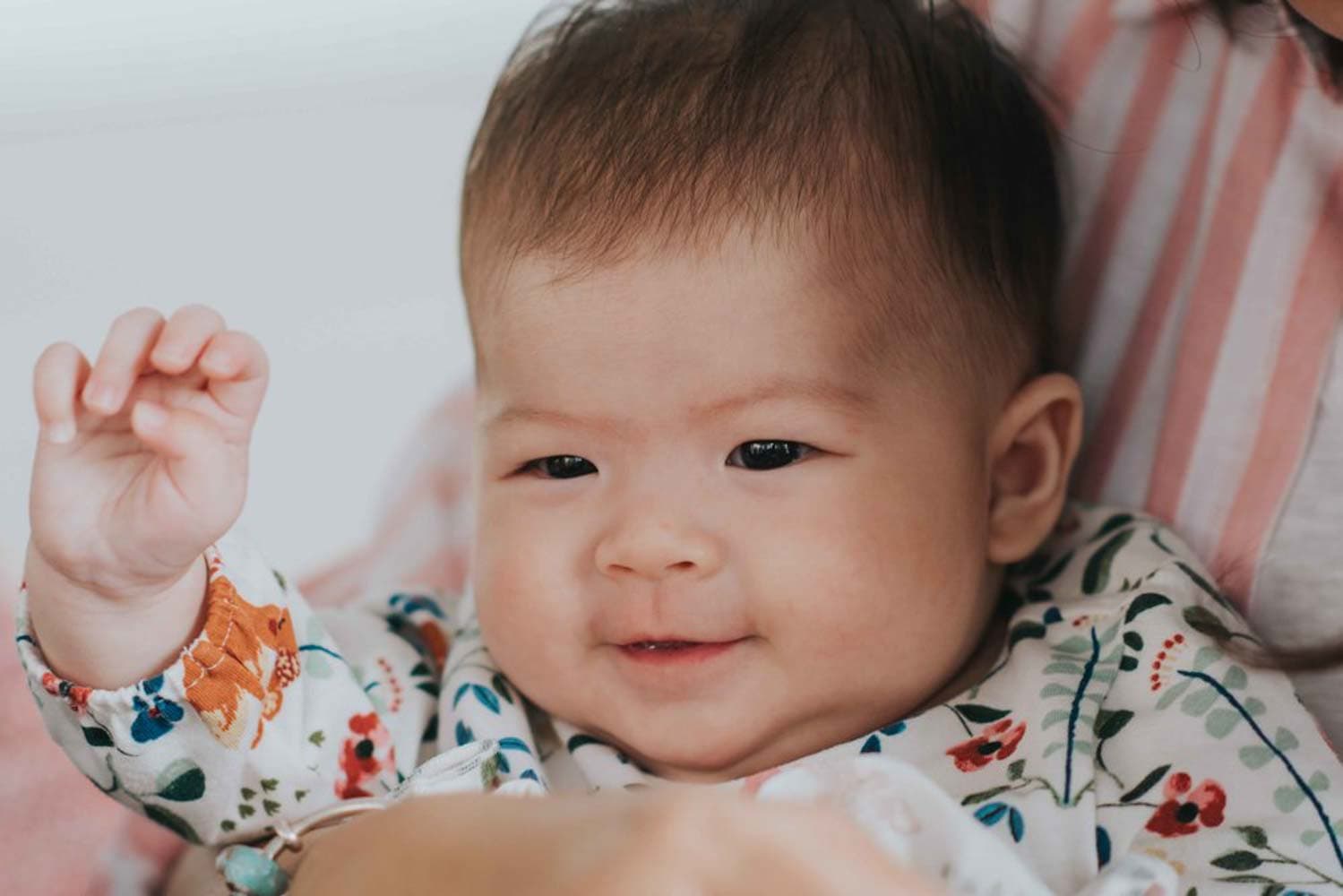 100 day old baby smiling at her baby shower celebration