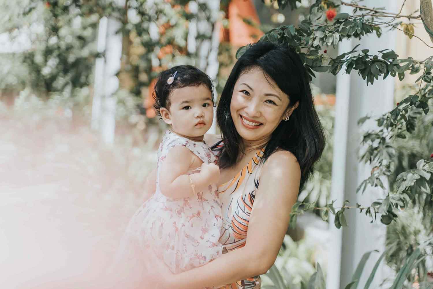 young mother hugging daughter for 1st kids birthday party celebration