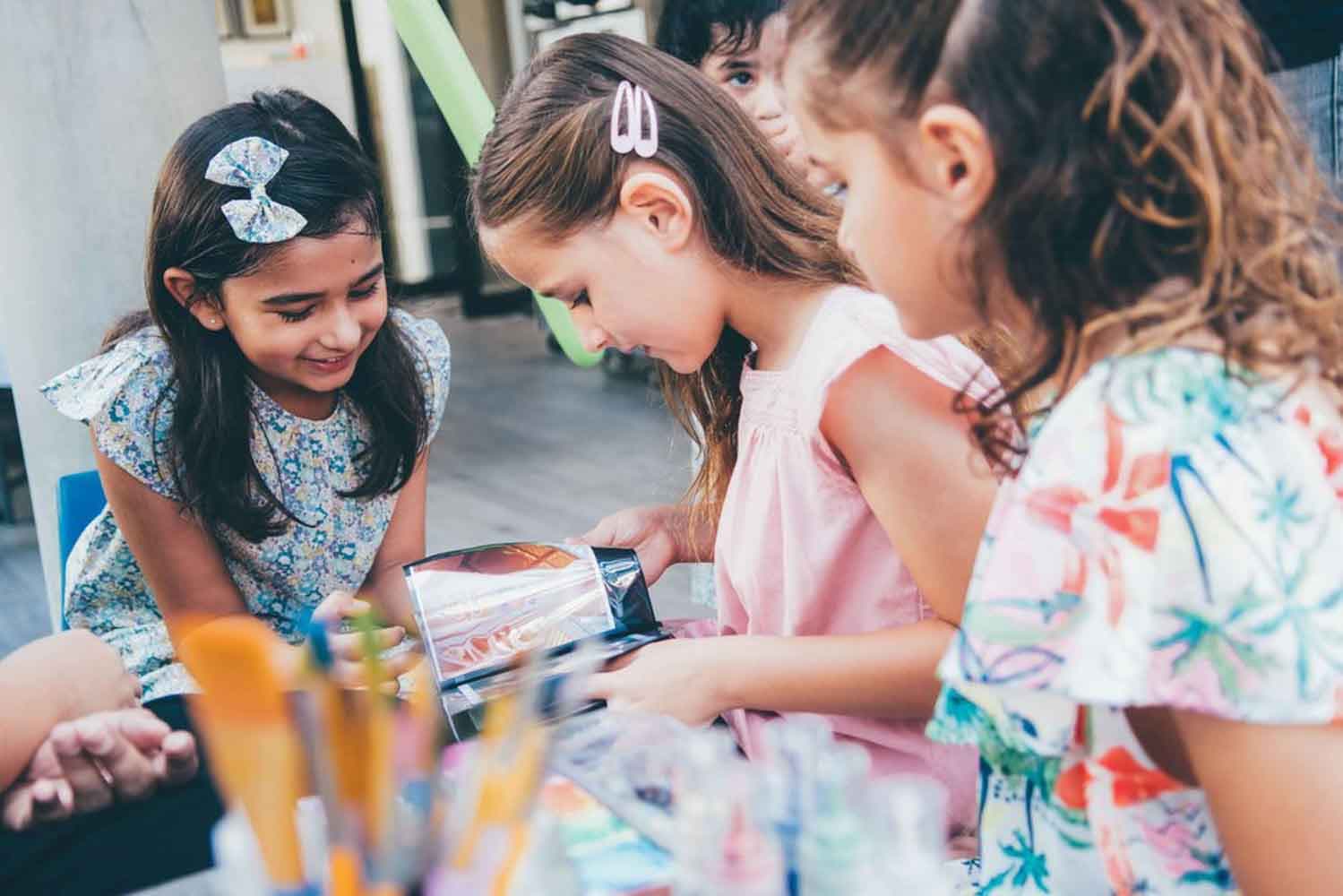 a group of kids doing hand art painting shot by event photographer for kids party
