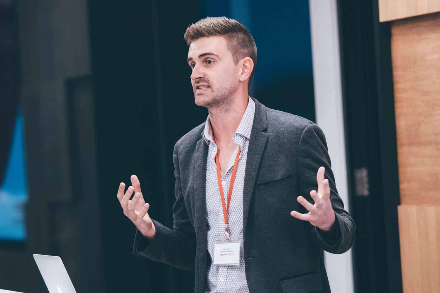 guy giving a presentation at the rakuten symposium at rakuten singapore office captured by professional photographer