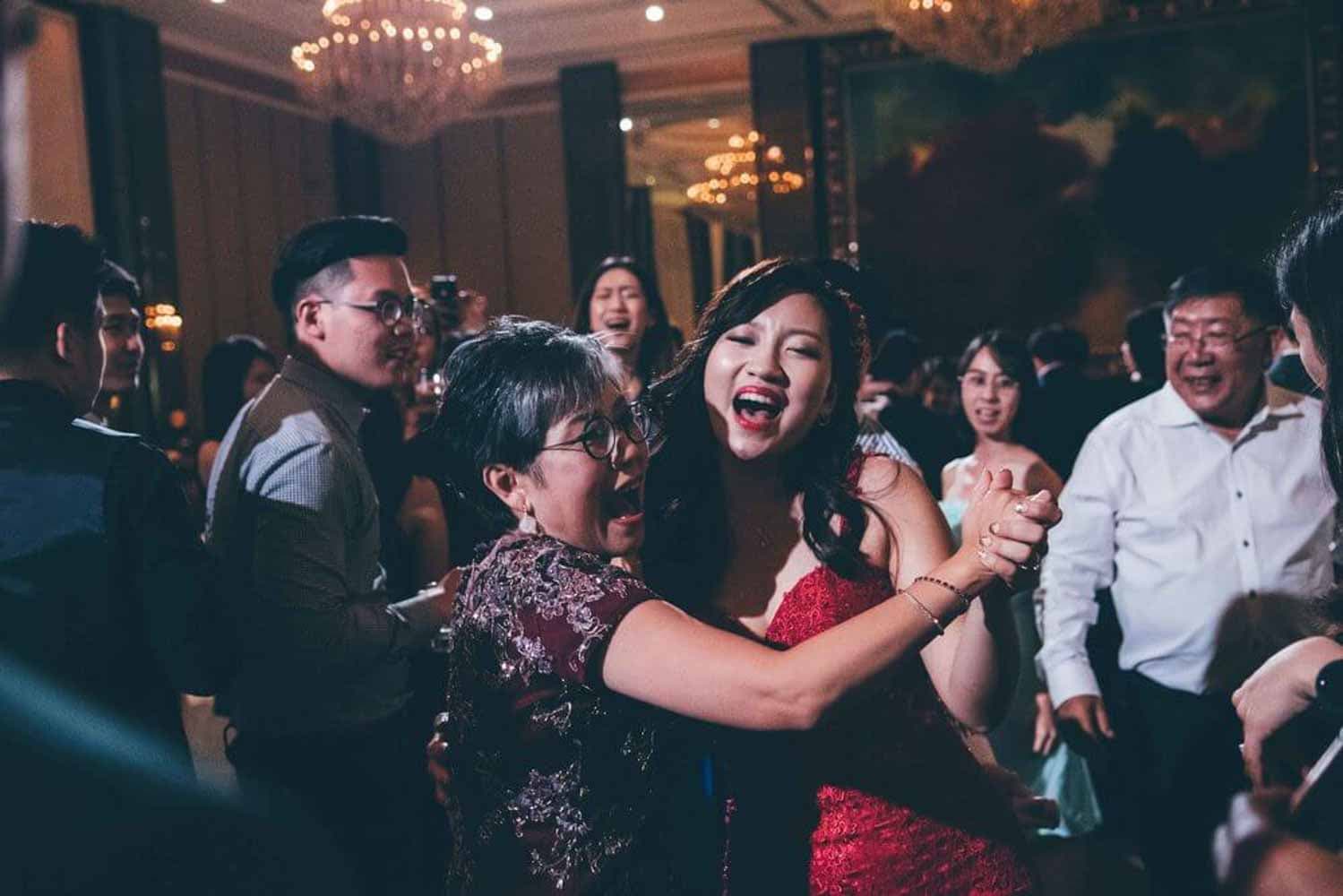 mother and daughter dancing in the wedding ballroom during wedding captured by event photographer in singapore