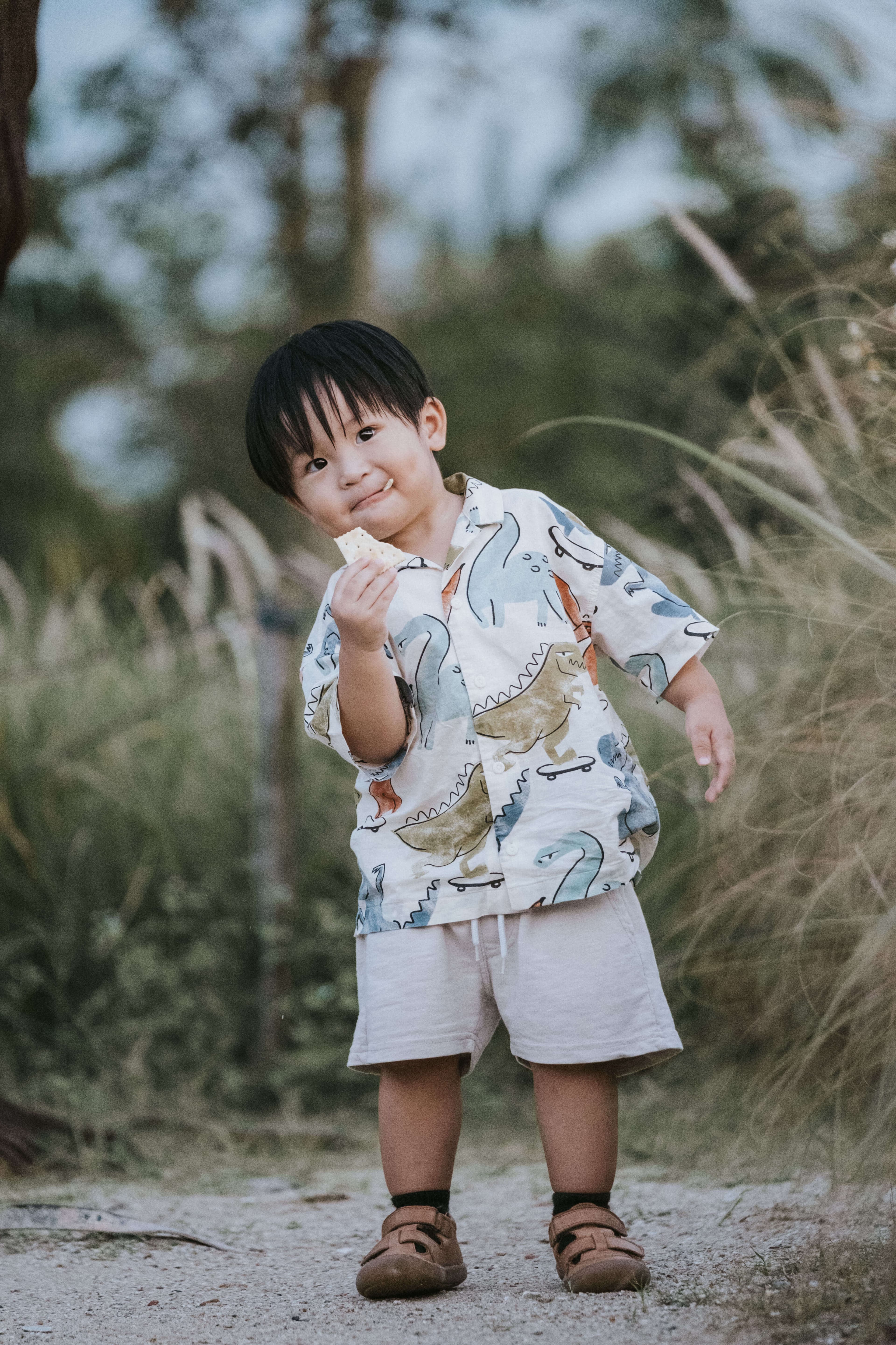 kid snacking on a biscuit during a photography shoot